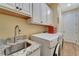 Laundry room with white cabinets, granite countertop, and a sink at 118 Creek Se Dr, Port Charlotte, FL 33952
