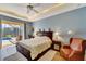 Main bedroom with a king-size bed and access to the pool at 118 Creek Se Dr, Port Charlotte, FL 33952