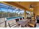 Screened-in pool area with patio furniture and a dining table at 118 Creek Se Dr, Port Charlotte, FL 33952
