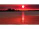 Stunning sunset over calm water with a picturesque waterfront view at 118 Creek Se Dr, Port Charlotte, FL 33952