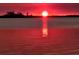 Stunning sunset over calm water with a picturesque waterfront view at 118 Creek Se Dr, Port Charlotte, FL 33952