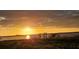 Breathtaking sunset over calm waters and a dock at 118 Creek Se Dr, Port Charlotte, FL 33952