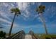 Wooden walkway leads to the beach under a bright sky at 1800 Benjamin Franklin Dr # A304, Sarasota, FL 34236