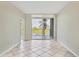 Spacious bedroom with tile flooring and sliding glass doors to balcony at 1800 Benjamin Franklin Dr # A304, Sarasota, FL 34236