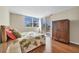 Bedroom with hardwood floors and access to a balcony at 1800 Benjamin Franklin Dr # A304, Sarasota, FL 34236