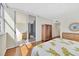 Main bedroom with hardwood floors and balcony access at 1800 Benjamin Franklin Dr # A304, Sarasota, FL 34236