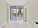 View of the balcony from dining area with tiled floors at 1800 Benjamin Franklin Dr # A304, Sarasota, FL 34236