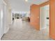 Bright entryway with tile floors and orange accent wall at 1800 Benjamin Franklin Dr # A304, Sarasota, FL 34236