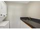 Convenient laundry area with stackable washer/dryer and granite countertop at 1800 Benjamin Franklin Dr # A304, Sarasota, FL 34236