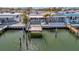 Aerial view of a waterfront home with a private boat dock, showcasing its location and stunning water access at 19 Seaside Ct, Holmes Beach, FL 34217