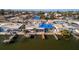 Aerial view of the property, showing a canal-front home with a damaged roof at 19 Seaside Ct, Holmes Beach, FL 34217