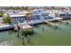 Aerial view showcasing the waterfront home with private boat dock, illustrating its location on the water at 19 Seaside Ct, Holmes Beach, FL 34217