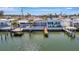 Aerial shot showcasing a waterfront home with multiple docks, perfect for boating enthusiasts and water access at 19 Seaside Ct, Holmes Beach, FL 34217