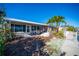 Backyard with canal views, small boat, and partially covered patio at 19 Seaside Ct, Holmes Beach, FL 34217