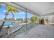 Relaxing covered patio with picturesque waterfront views and private dock access, enhancing outdoor living at 19 Seaside Ct, Holmes Beach, FL 34217