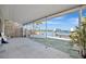Covered patio with waterfront views, showcasing the outdoor living space and dock access at 19 Seaside Ct, Holmes Beach, FL 34217