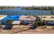 Waterfront home with carport and blue tarp at 19 Seaside Ct, Holmes Beach, FL 34217