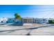 Two-story home with teal and gray exterior, covered carport, and fenced yard at 19 Seaside Ct, Holmes Beach, FL 34217