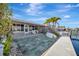 The spacious patio leads to a private dock, perfect for outdoor relaxation and enjoying waterfront living at 19 Seaside Ct, Holmes Beach, FL 34217