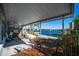 Covered patio overlooking the canal, with table and boat at 19 Seaside Ct, Holmes Beach, FL 34217