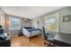 Bright bedroom with wood floors, window seating, and built-in shelving at 2111 Outer Dr, Sarasota, FL 34231