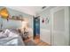 Sunny bedroom with a full-size bed and teal door at 2111 Outer Dr, Sarasota, FL 34231