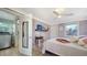 Bedroom with a queen bed, TV, and access to the bathroom at 2111 Outer Dr, Sarasota, FL 34231