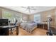 Spacious bedroom with a large bed, home office, and ceiling fan at 2111 Outer Dr, Sarasota, FL 34231