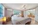 Spacious bedroom with a queen bed and access to the sunroom at 2111 Outer Dr, Sarasota, FL 34231