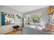 Charming bedroom with a twin bed, built-in shelving and large window at 2111 Outer Dr, Sarasota, FL 34231