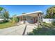 Charming light gray house with a covered patio and a spacious yard at 2111 Outer Dr, Sarasota, FL 34231