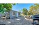 Rear view of the light blue house with patio and landscaping at 2111 Outer Dr, Sarasota, FL 34231