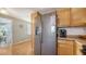 Modern kitchen with stainless steel fridge and wood cabinets at 2111 Outer Dr, Sarasota, FL 34231