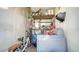 Small laundry room with washer, storage shelves, and bike at 2111 Outer Dr, Sarasota, FL 34231