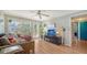 Living room features hardwood floors, a large TV and access to a back patio at 2111 Outer Dr, Sarasota, FL 34231