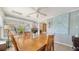 Sunroom dining area with large artwork and abundant natural light at 2111 Outer Dr, Sarasota, FL 34231