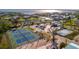 Aerial view showing community amenities, including tennis courts near the waterfront at 23 Seaside Ct, Holmes Beach, FL 34217