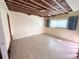 Bright bedroom with tile flooring, a large window, and exposed ceiling beams at 23 Seaside Ct, Holmes Beach, FL 34217