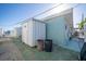Home exterior with storage shed and trash cans at 23 Seaside Ct, Holmes Beach, FL 34217