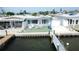 Waterfront home featuring a private dock, patio, and charming exterior details, perfect for coastal living at 23 Seaside Ct, Holmes Beach, FL 34217