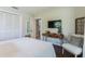 Cozy bedroom with a comfortable bed, TV, and built-in closet at 2321 Milford Cir, Sarasota, FL 34239