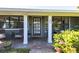 Charming front porch with a green door and brick facade at 2321 Milford Cir, Sarasota, FL 34239