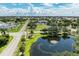 Aerial view of residential area with pond and landscaping at 25318 Marion Ave, Punta Gorda, FL 33950