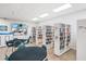 Community library with tables, chairs, and extensive book collection at 3213 Sumac Ter, Sarasota, FL 34237