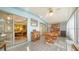 Bright enclosed patio with wood table and chairs, offering extra living space at 3213 Sumac Ter, Sarasota, FL 34237