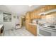 White appliances and wood cabinets in this kitchen at 3213 Sumac Ter, Sarasota, FL 34237