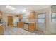 Bright kitchen with wood cabinets and tile floor at 3213 Sumac Ter, Sarasota, FL 34237