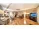 Living room features hardwood floors, ample seating, and a large TV at 3213 Sumac Ter, Sarasota, FL 34237