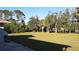 Large grassy backyard with mature trees and waterway at 3405 22Nd Street W Ct, Bradenton, FL 34205