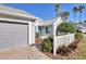 Gray garage door and walkway to villa entrance with well-manicured landscaping at 3529 52Nd Avenue W Cir, Bradenton, FL 34210